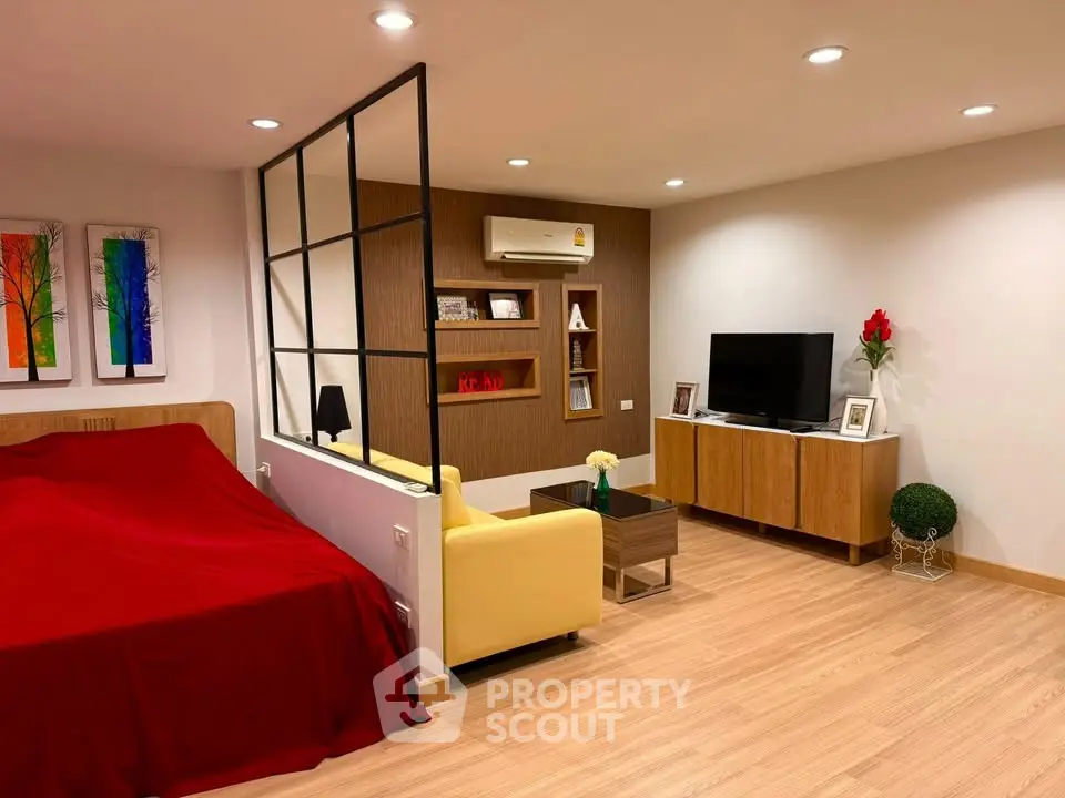 Modern studio apartment with stylish decor and cozy living area.