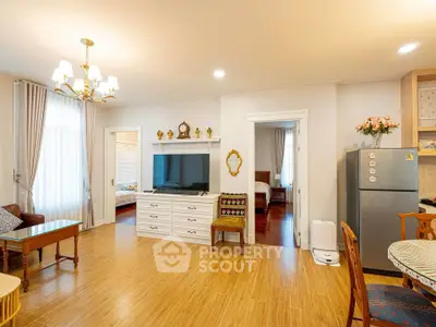 Spacious living room with elegant decor and modern appliances in a cozy apartment.
