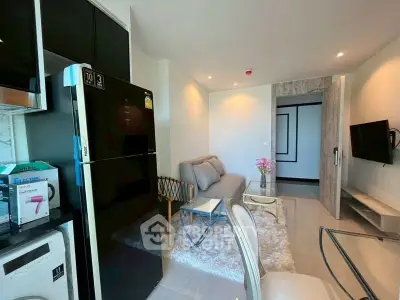 Modern living room with sleek furniture and open kitchen in a stylish apartment.