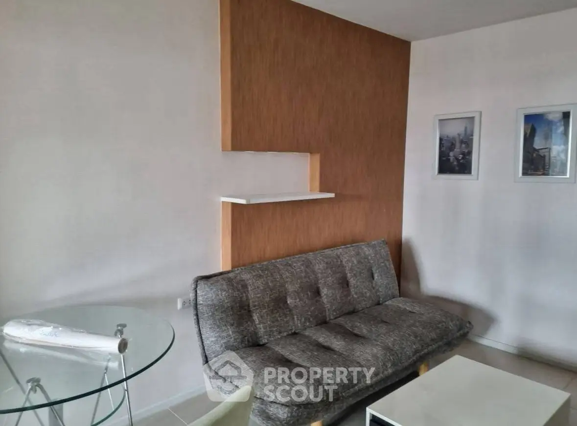 Modern living room with stylish sofa and glass table in a cozy apartment.