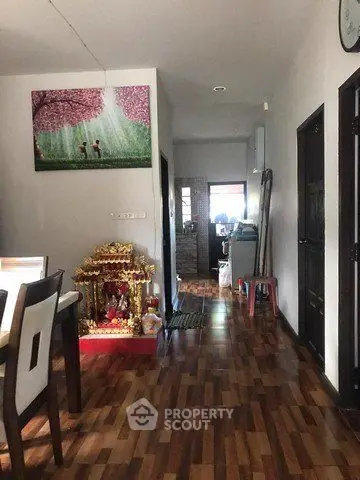 Charming interior hallway with wooden flooring and decorative elements, leading to a cozy dining area.