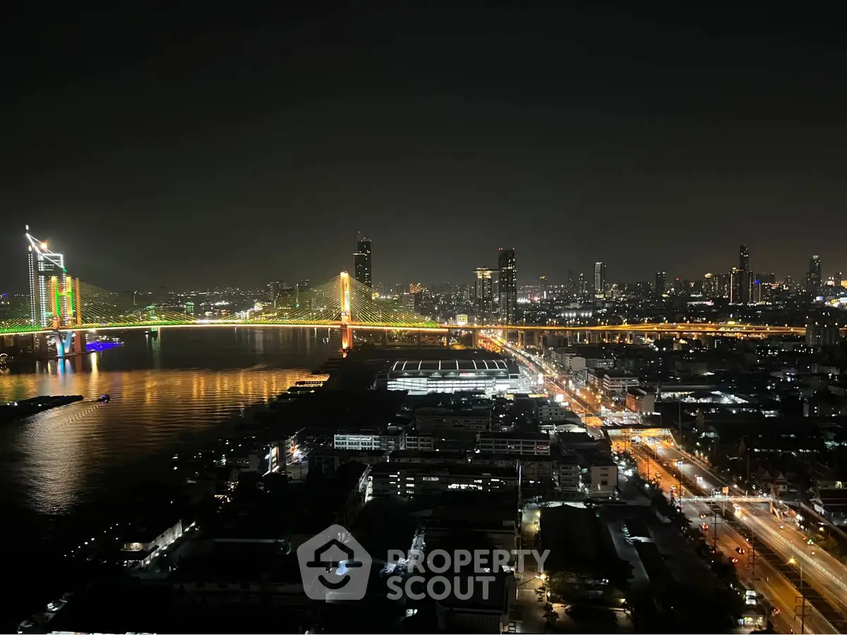 Stunning night view of city skyline with illuminated bridge and river