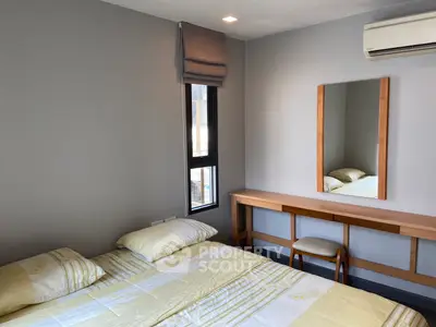 Cozy bedroom with modern decor, featuring a comfortable bed and stylish wooden furniture.