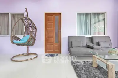 Modern living room with stylish swing chair and cozy gray sofa