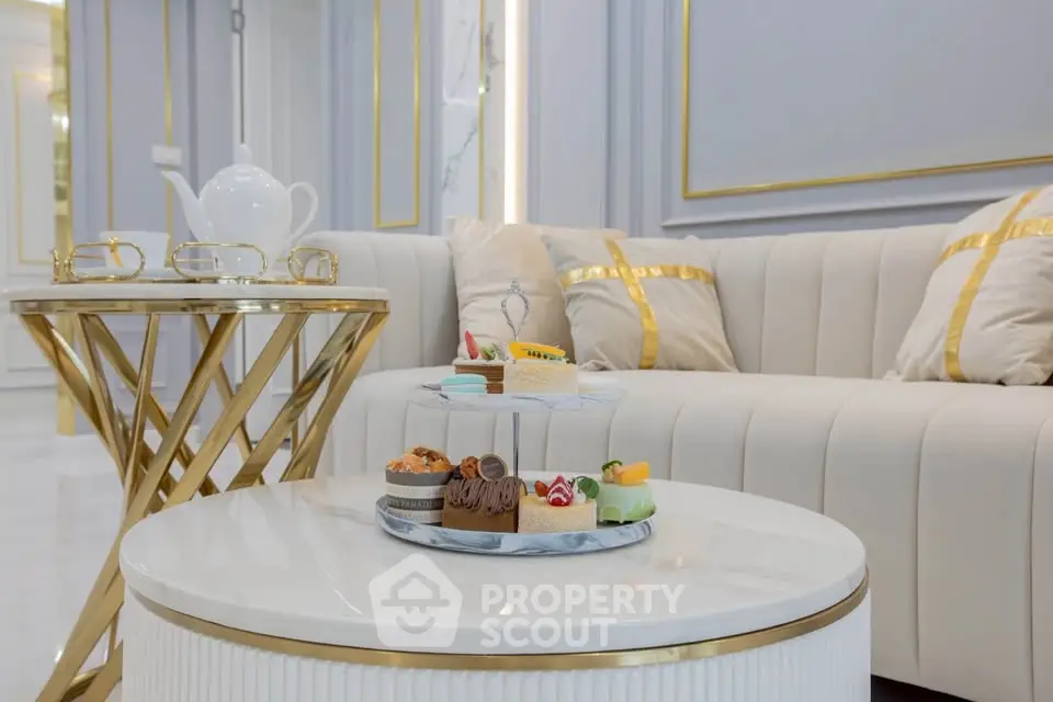 Luxurious living room with elegant sofa and stylish coffee tables, perfect for sophisticated gatherings.