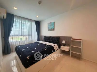 Modern bedroom with stylish decor and large window in a contemporary apartment.