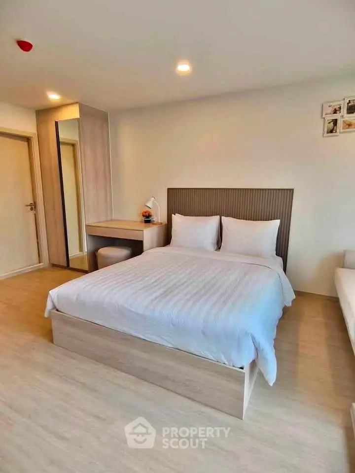 Modern bedroom with cozy bed and stylish decor in a bright apartment.