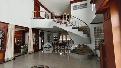 Spacious luxury living room with elegant staircase and modern design
