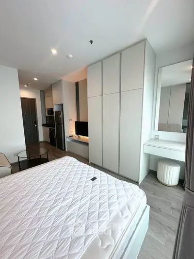 Modern bedroom with sleek design, built-in wardrobe, and cozy ambiance in a stylish apartment.