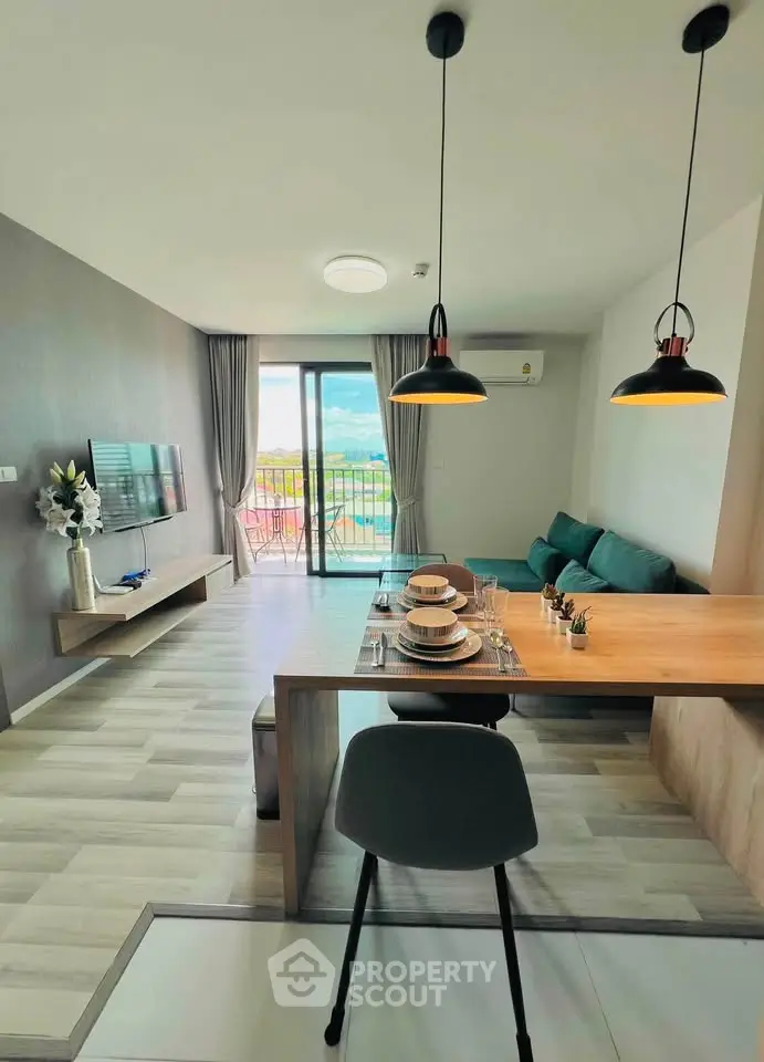 Modern living room with stylish dining area and balcony view