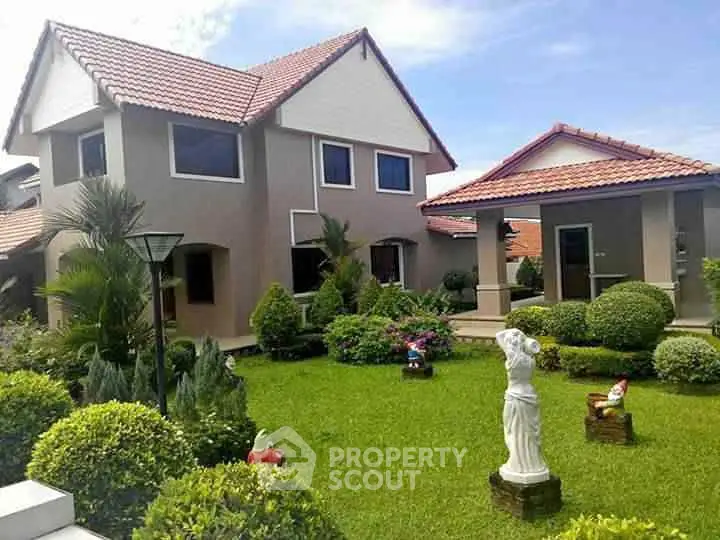 Charming suburban home with lush garden and elegant statue, perfect for family living.
