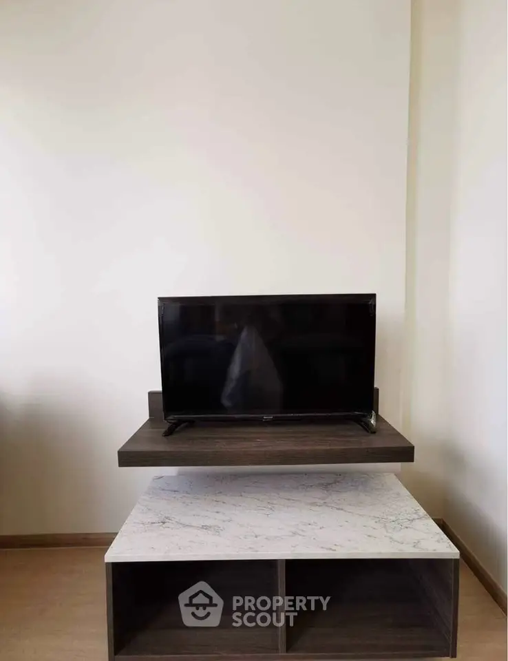Modern living room with sleek TV stand and marble accent table