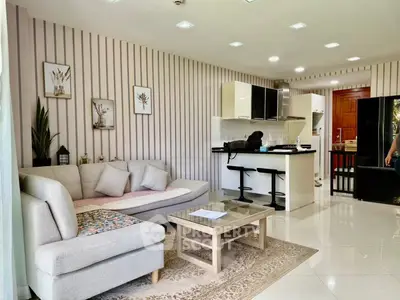 Modern open-layout living room with stylish kitchen and cozy seating area