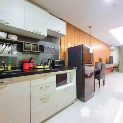 Modern kitchen with sleek white countertops, wooden accents, and state-of-the-art appliances, perfect for culinary enthusiasts.