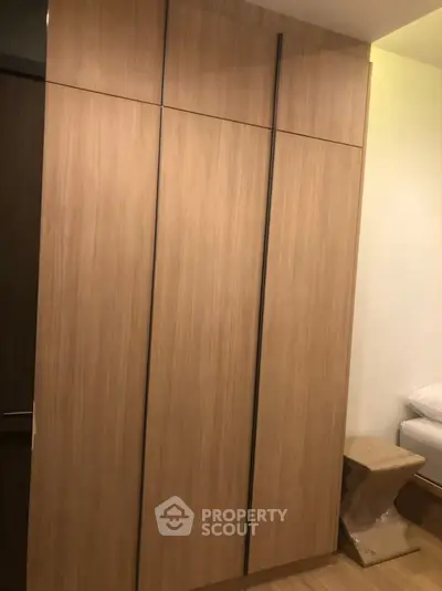 Modern bedroom with sleek wooden wardrobe and cozy ambiance