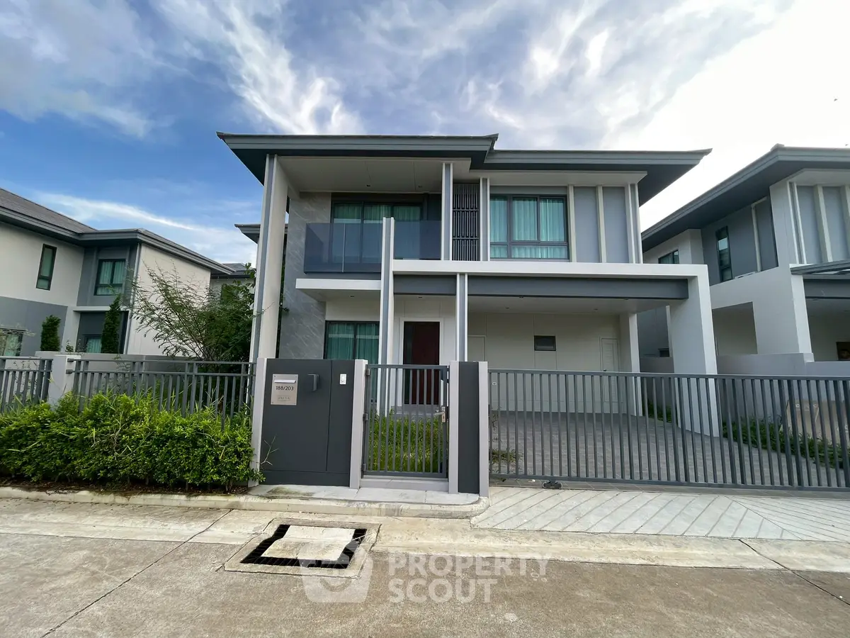 Modern two-story house with sleek design and spacious driveway in a serene neighborhood.