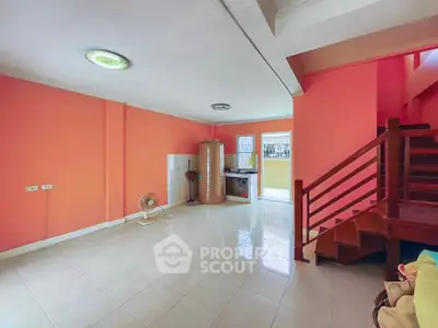 Spacious interior with vibrant walls and staircase, ideal for creative living space.