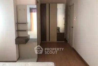 Spacious bedroom with modern wardrobe and wooden flooring