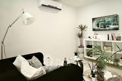 Modern living room with sleek black sofa and stylish decor