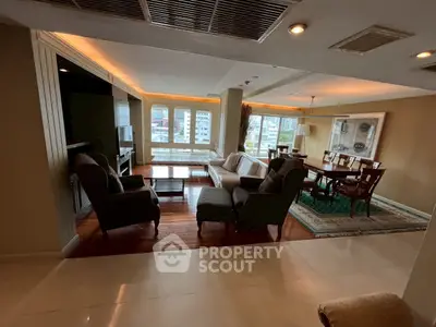 Spacious living and dining area with elegant decor and city view.