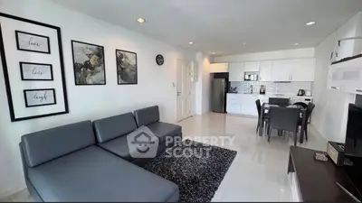 Modern open-plan living room with sleek kitchen and stylish decor