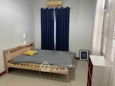 Cozy bedroom with minimalist decor and natural light, featuring a wooden bed frame and stylish curtains.