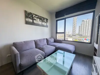 Modern living room with gray sofa and city view through large windows