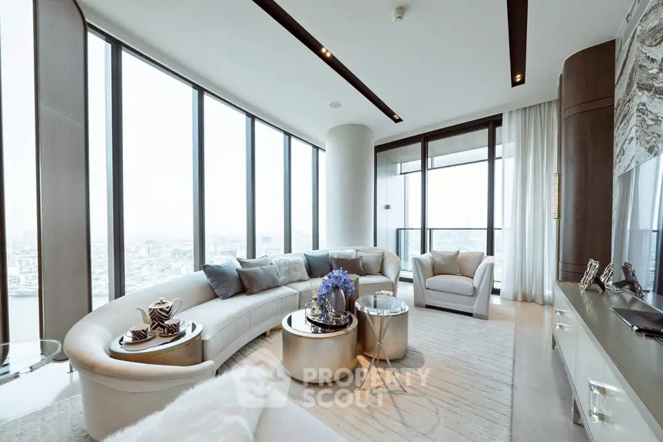Luxurious modern living room with panoramic city views and elegant furnishings.