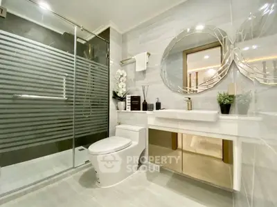 Luxurious modern bathroom with glass shower and elegant decor