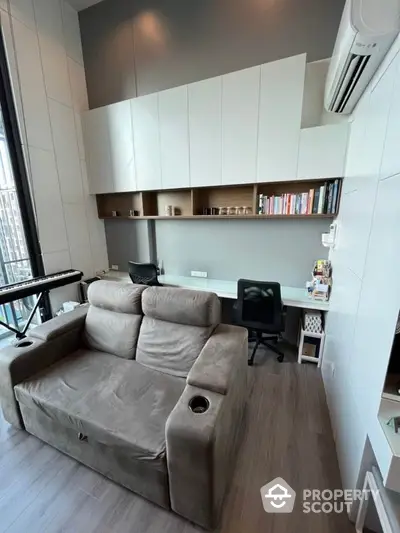 Modern study room with cozy sofa and built-in desk in high-rise apartment