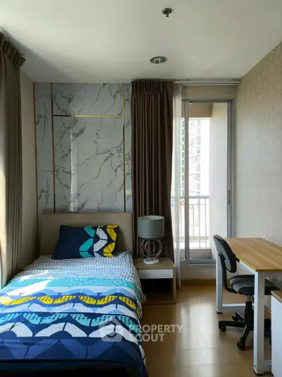 Modern bedroom with balcony access and stylish decor in a high-rise apartment.