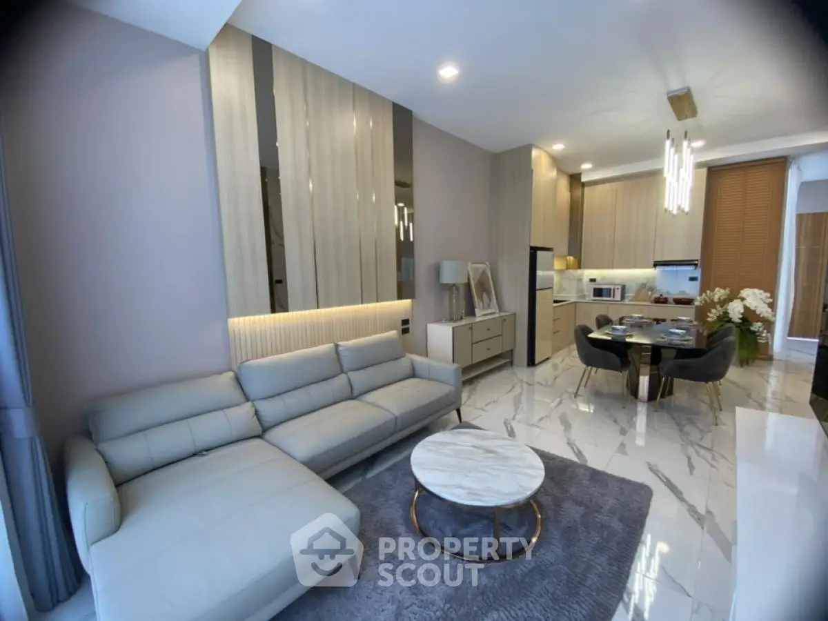 Modern living room with elegant decor and open kitchen layout