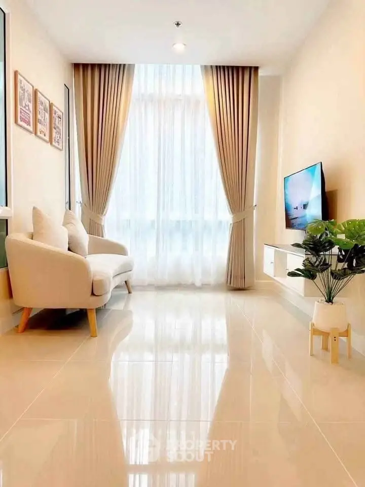 Bright modern living room with large window, elegant curtains, and cozy seating area.