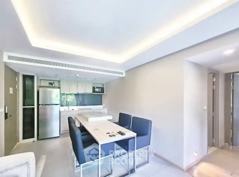Modern kitchen and dining area with sleek design and ample natural light.