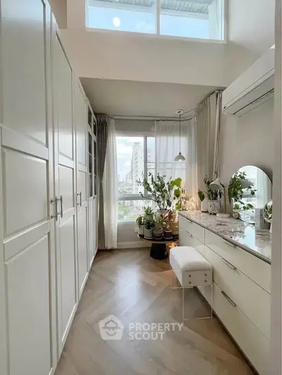 Elegant study room with natural light, modern decor, and city view.
