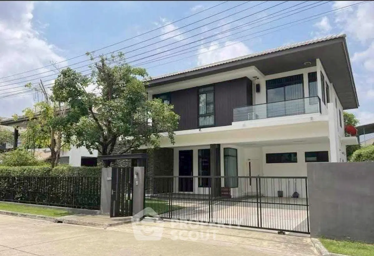 Modern two-story house with sleek design and spacious driveway in a serene neighborhood.
