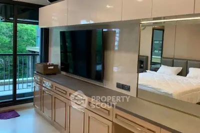 Luxurious bedroom with modern cabinetry and balcony view, perfect for serene living.