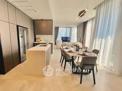 Luxurious open-plan kitchen and dining area with modern furnishings and ample natural light.