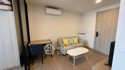 Modern living room with cozy sofa, desk, and air conditioning in a stylish apartment.