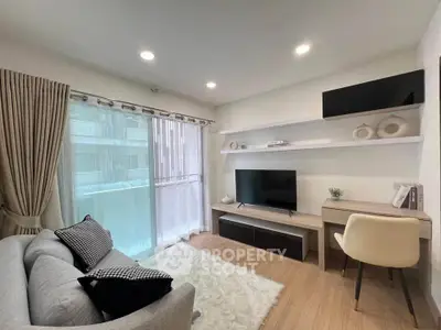 Modern living room with cozy decor, large window, and stylish furniture in a bright apartment.