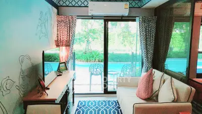 Charming living room with pool view, stylish decor, and cozy seating area perfect for relaxation.