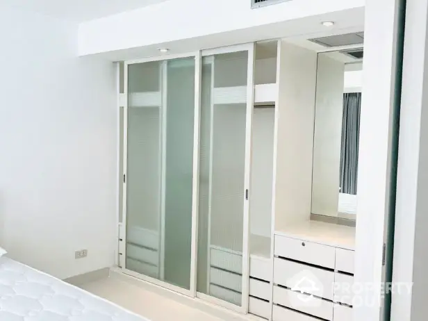 Modern bedroom with sleek built-in wardrobe and minimalist design