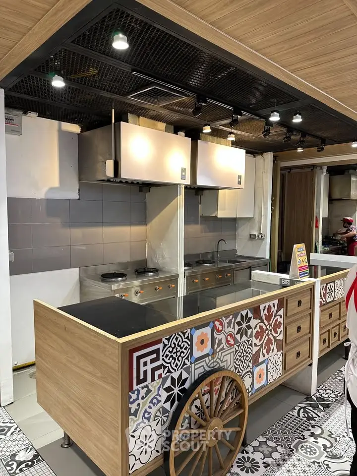 Stylish kitchen with unique tile design and modern appliances