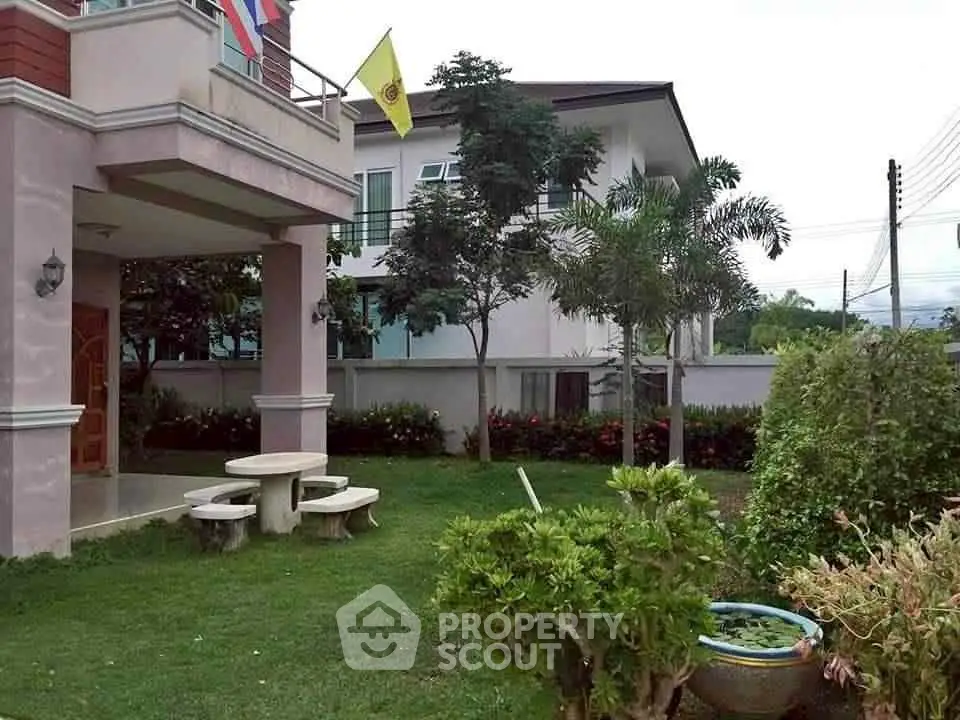 Charming suburban home with lush garden and inviting outdoor seating area.