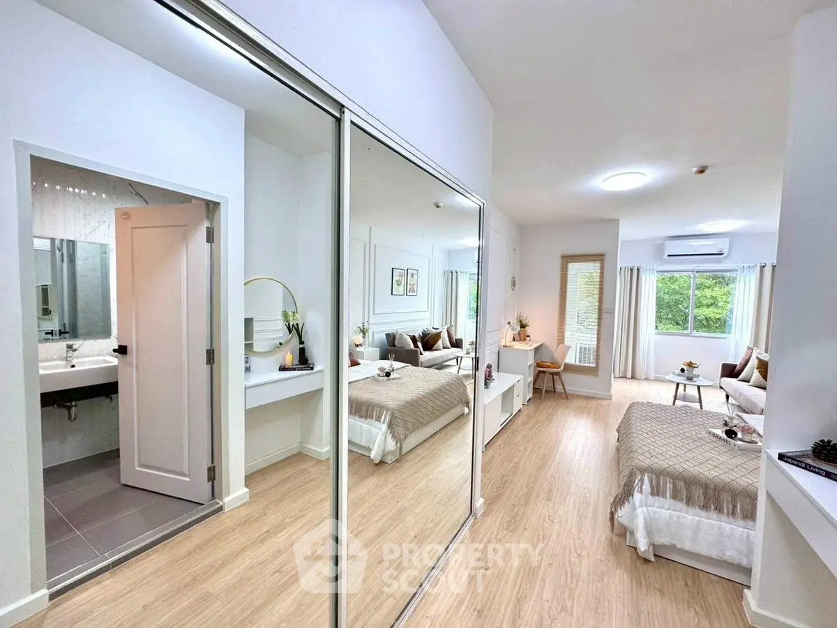 Modern bedroom with mirrored closet and cozy decor in bright apartment