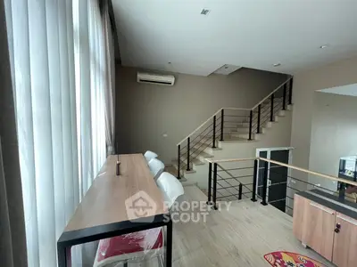 Modern duplex interior with stylish staircase and natural light