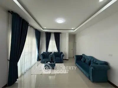 Spacious living room with elegant blue sofas and natural light
