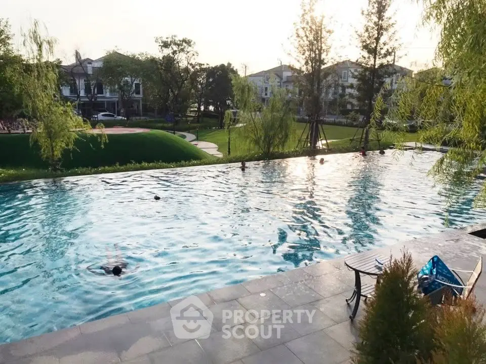 Luxurious residential pool with serene garden view, perfect for relaxation and leisure.