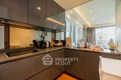 Modern kitchen with sleek cabinetry and open layout in luxury apartment