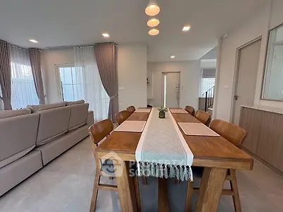 Spacious modern living room with elegant dining area and natural light